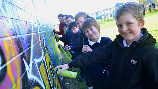 Local schoolchildren graffiti different ways of saying hello on a wall. Photo: Steve Smailes for The Lincolnite.