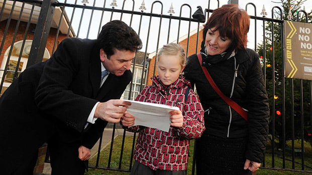 Chief Executive of City of Lincoln Council Andrew Taylor reads Sophie's letter with mum Karen outside her school. Photo: Stuart Wilde