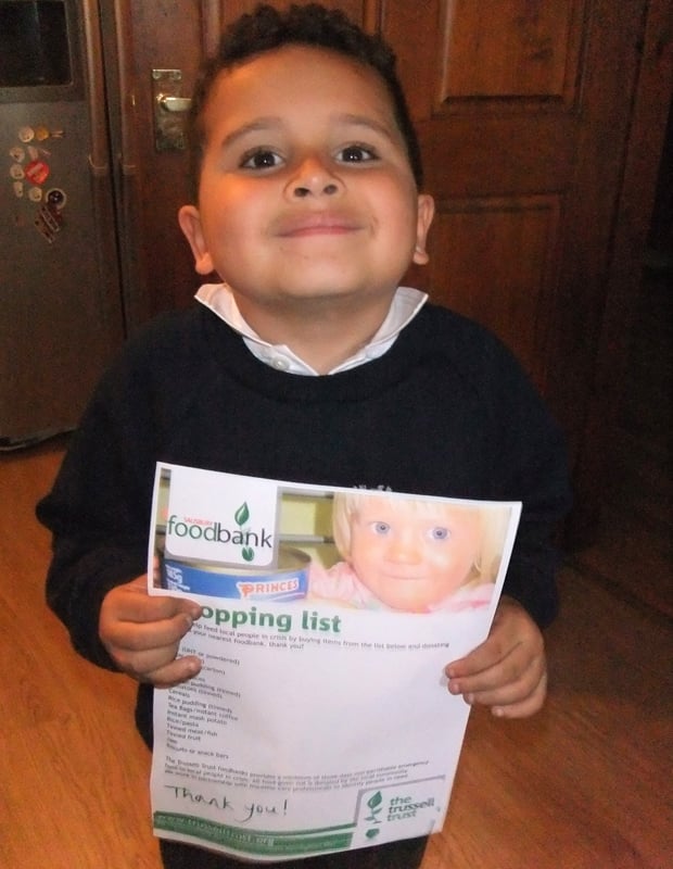 Theo receiving an official shopping list from the Trussell Trust.