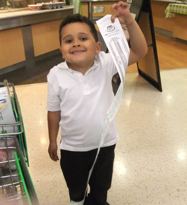 Theo's shopping receipt was almost as tall as him.