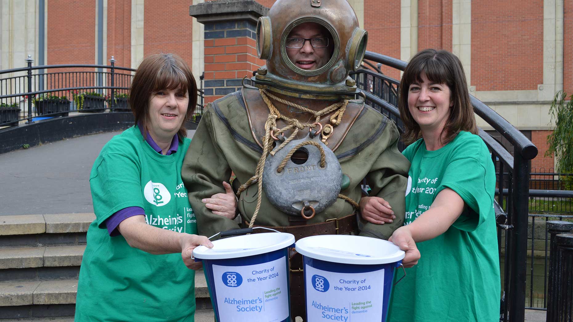 Lincolnshire Co-op Customer Sales Assistant Jayne McDougall, City Square Food Store Manager Phil Goddard and Lincolnshire Co-op’s City Square Coffee Shop Manager Debbie Wright (who owns the diving suit). Photo: Lincolnshire Co-op