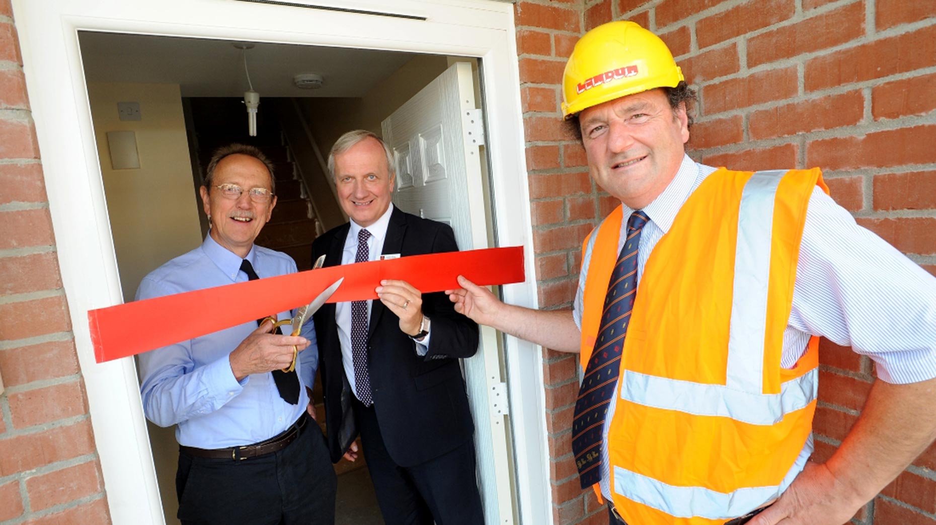 Council Leader Ric Metcalfe, Chief Executive Andrew Taylor, Director of Housing and Community Services John Bibby and Chairman of Lindum Group, David Chambers, celebrate the completion of five new council homes in Stapleford Avenue. Photo: Stuart Wilde