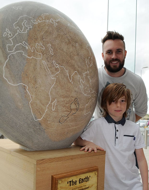 Tyler Goy (9) with sculpter James Sutton.