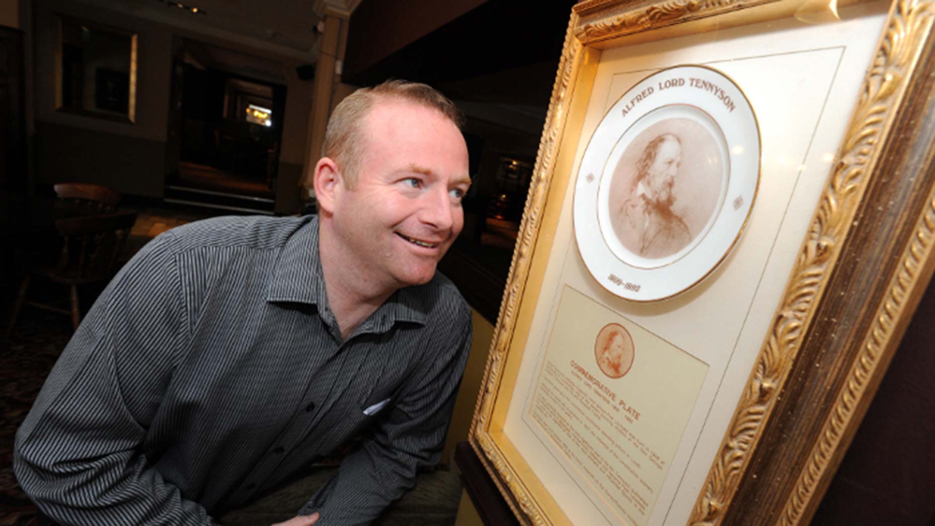 Matthew Gillet looking at a Tennyson plate in the Woodcocks pub (which Matthew manages).