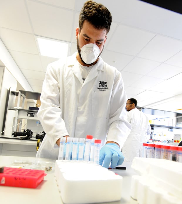 A PhD student works on DNA extraction in the Molecular Biology Lab. Photo: UoL