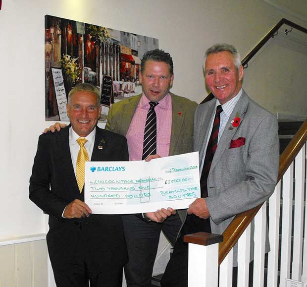 Karl hands over cheque to Lincoln Tank Memorial representatives.