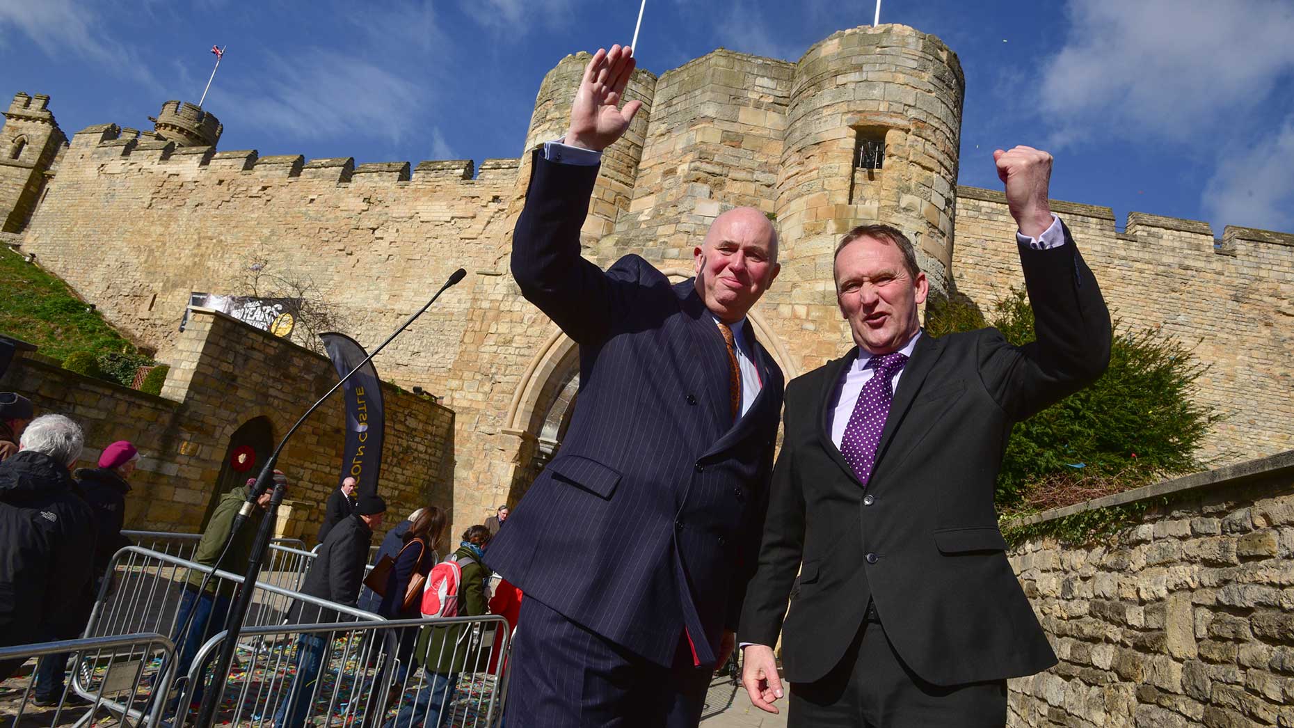 Councillor Colin Davie and Councillor Nick Worth celebrating the opening day of Lincoln Castle after a £22 million revamp. Photo: Steve Smailes for The Lincolnite