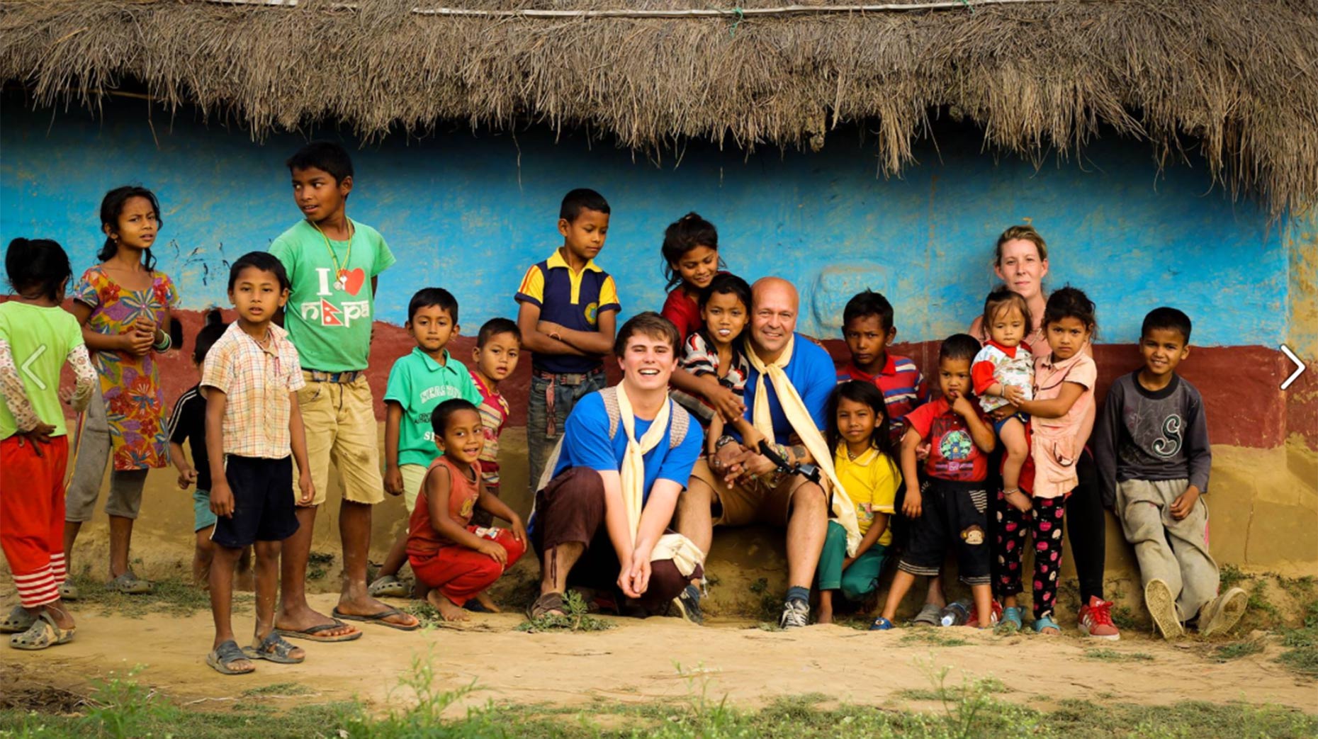 Garry and Leo with just some of the thousands of children the scheme has helped so far in Nepal.
