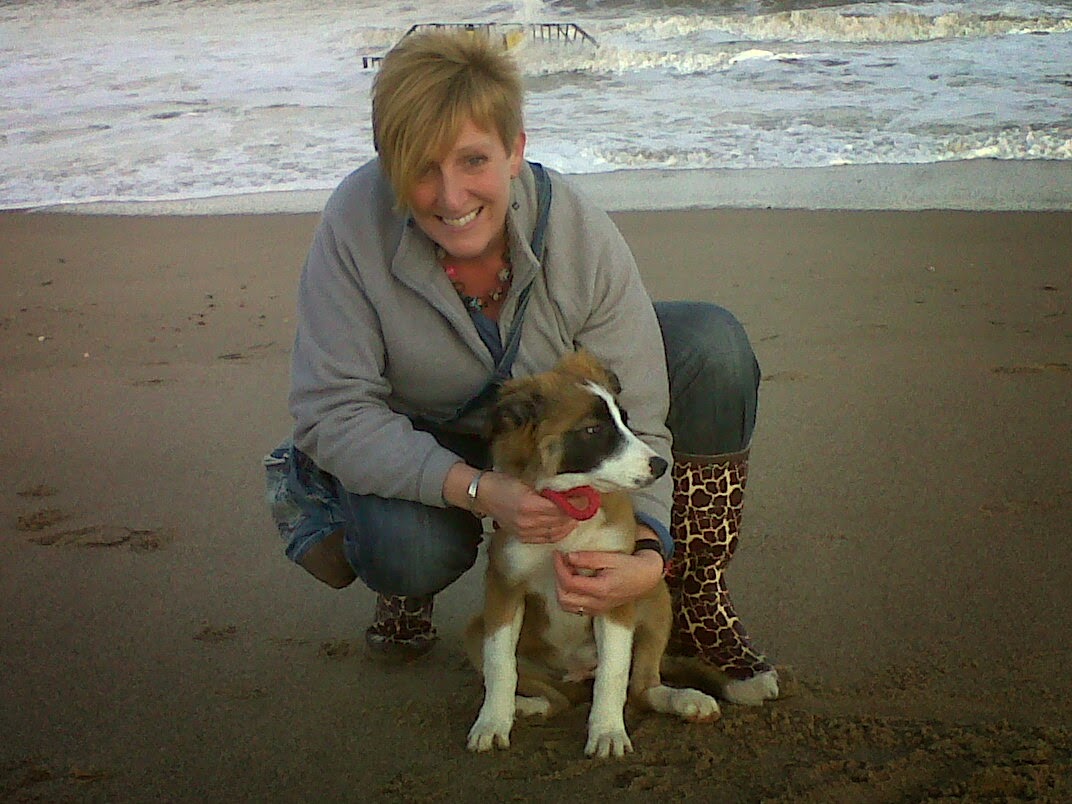 Cute as a button! Maya at the beach with owner Joanne when she was a puppy.