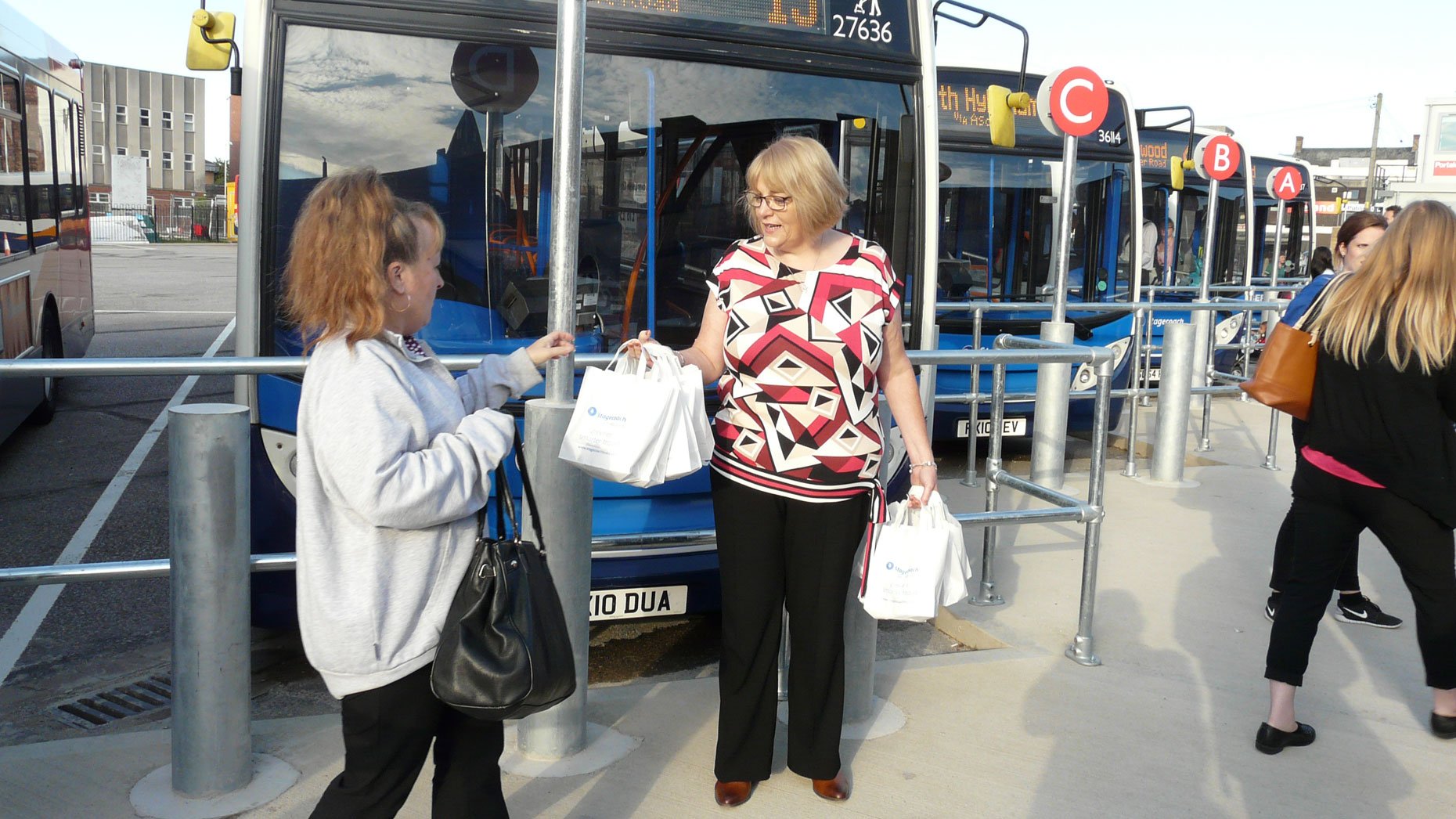 Managing Director Michelle Hargreaves handing out breakfast bags to loyal customers.