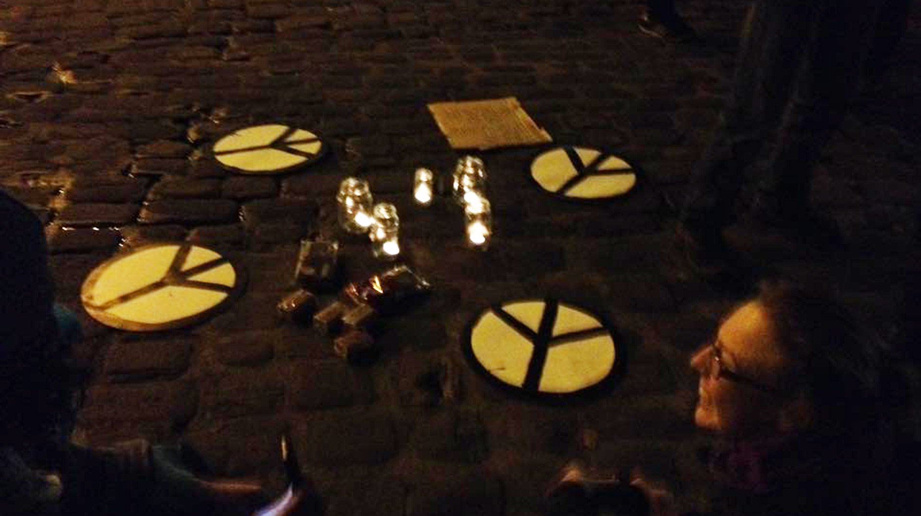 The group sat in a circle with candles and peace signs to discuss the presidential transition. 