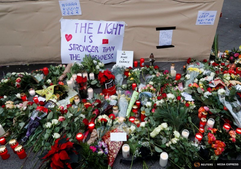Flowers and posters are placed at the scene where a truck ploughed into a crowded Christmas market in the German capital last night in Berlin, Germany, December 20, 2016. Photo: REUTERS/Fabrizio Bensch