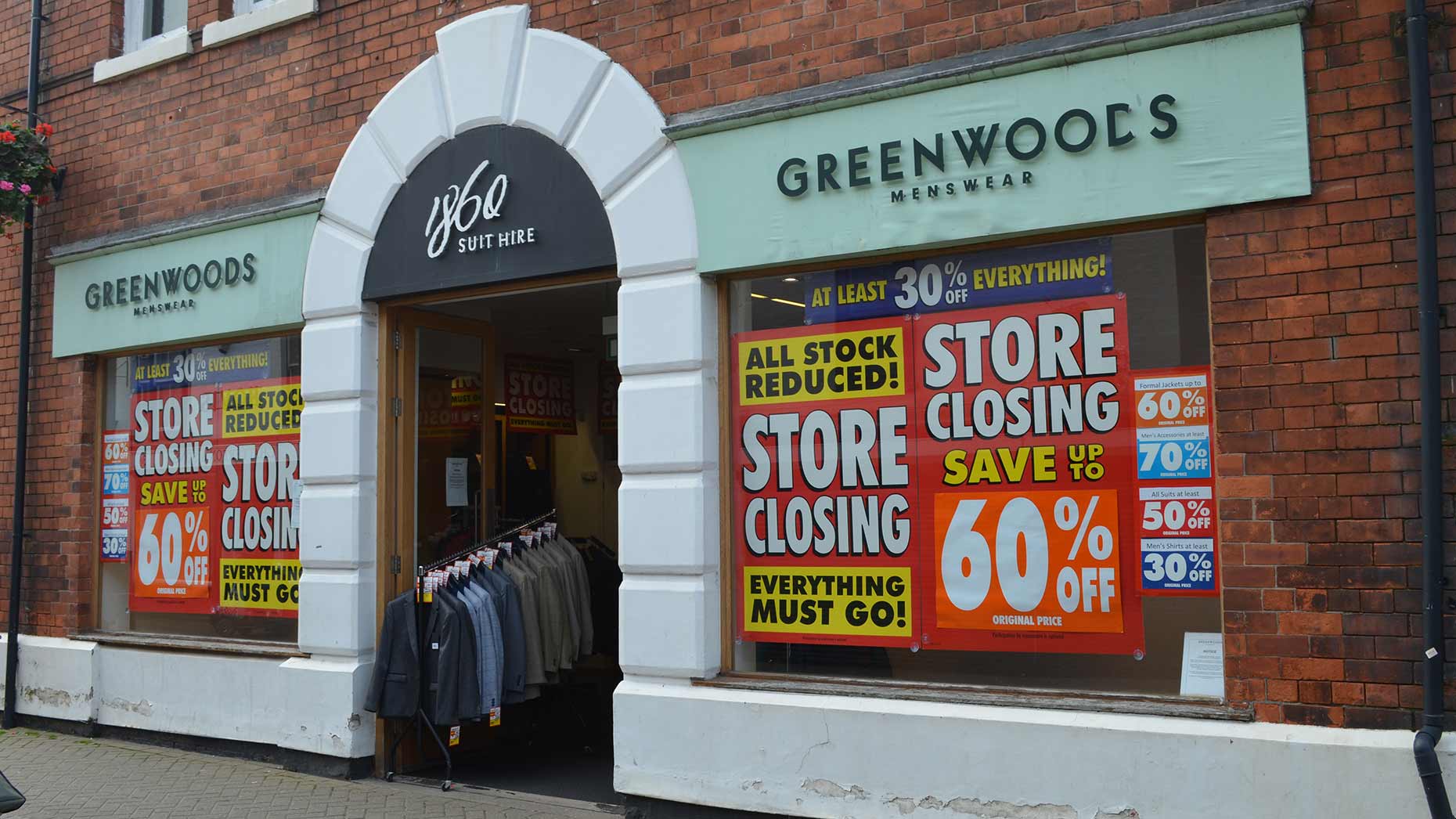 store-closing-signs-plastered-across-lincoln-menswear-shop